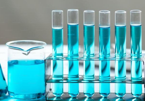 Chemistry laboratory glassware, science laboratory research and development concept, flask, beaker, and test tubes with blue liquid water sample test, scientific test tubes equipment